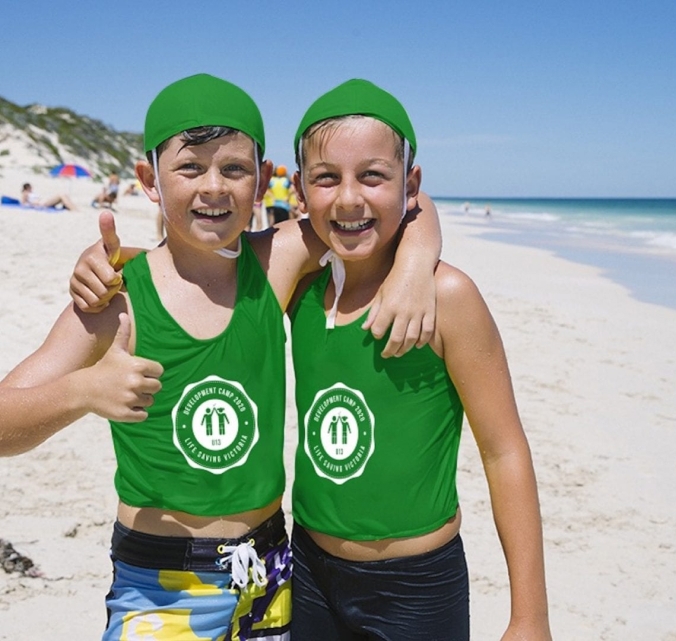 Two boys in green at the beach